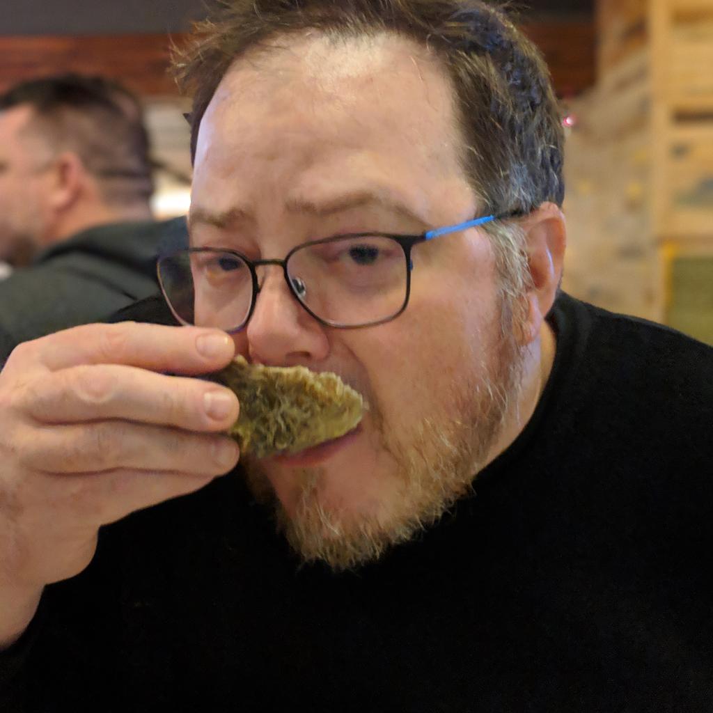 mike enjoying an oyster on the half shell.jpg